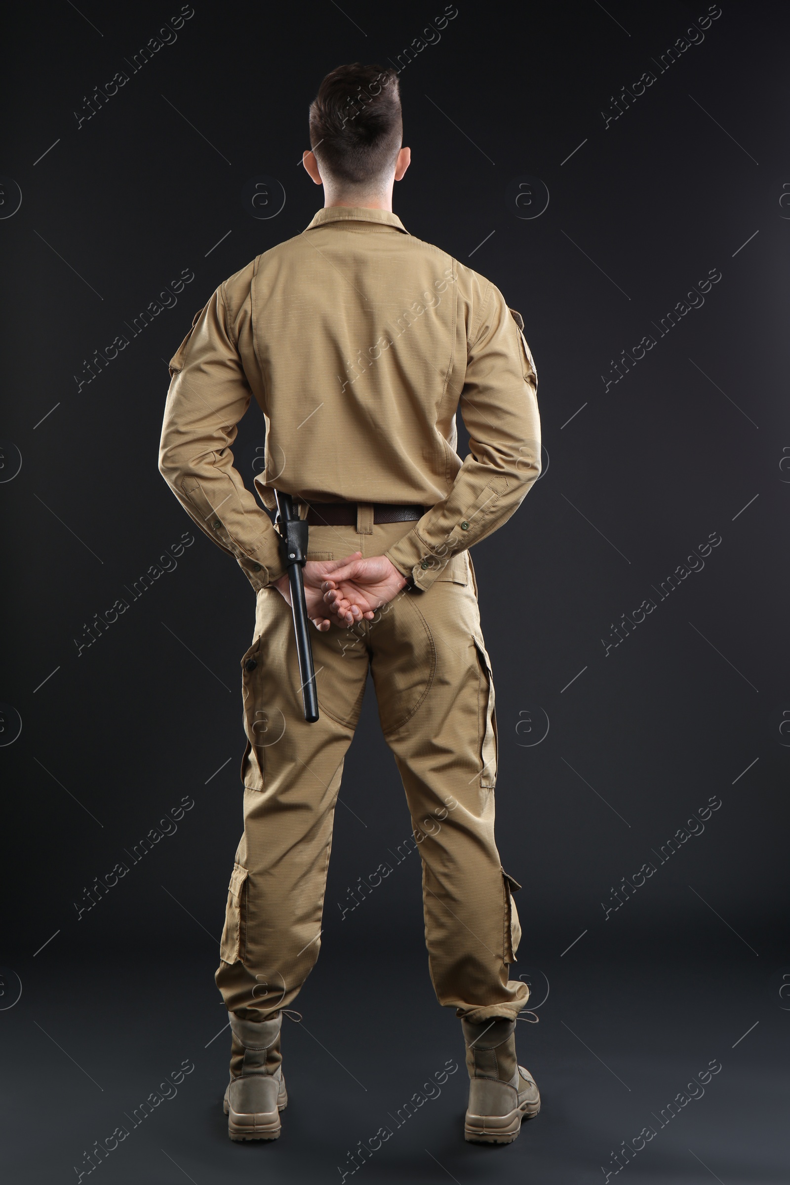 Photo of Male security guard in uniform on dark background