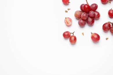 Photo of Composition with fresh ripe grapes and seeds on white background, top view