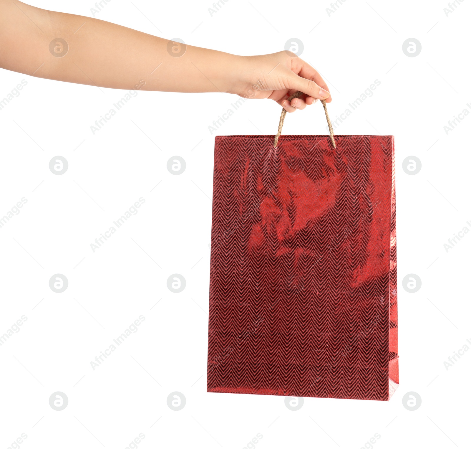 Photo of Woman holding red paper shopping bag on white background, closeup. Space for design