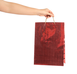 Photo of Woman holding red paper shopping bag on white background, closeup. Space for design