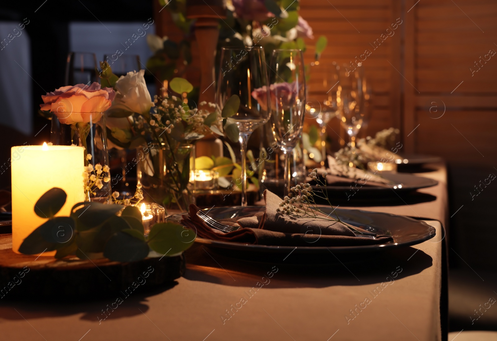 Photo of Elegant table setting with beautiful floral decor and burning candles