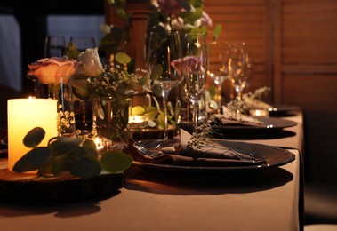 Elegant table setting with beautiful floral decor and burning candles