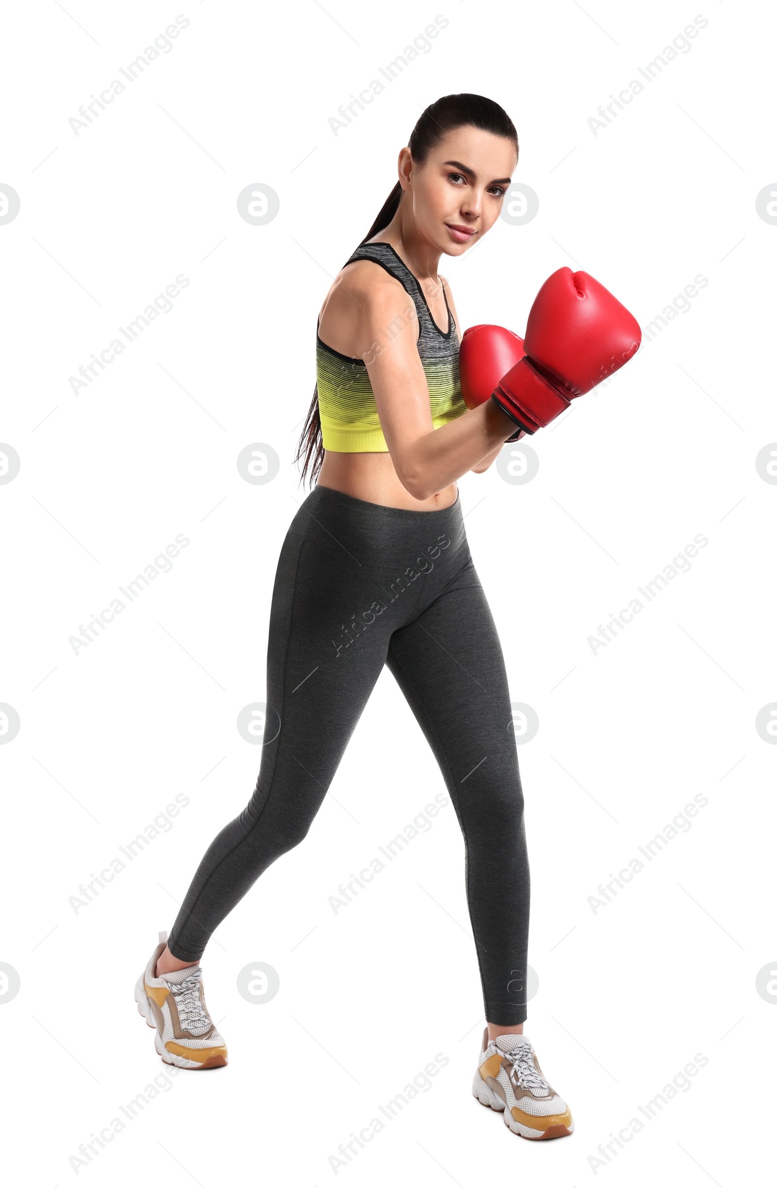 Photo of Beautiful woman in boxing gloves training on white background