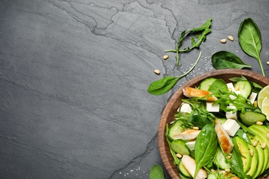 Delicious salad with chicken, arugula and avocado on black table, flat lay. Space for text