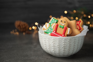 Tasty homemade Christmas cookies on dark grey table, space for text