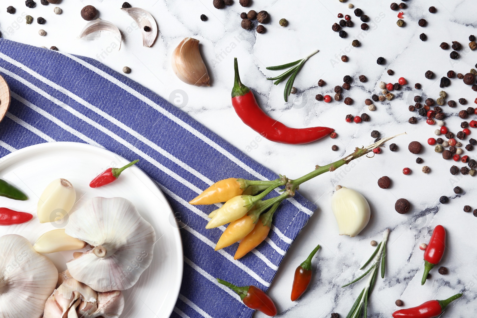 Photo of Flat lay composition with garlic and peppers on marble table