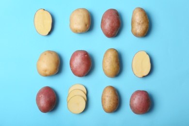 Flat lay composition with fresh organic potatoes on color background