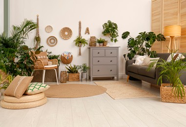 Living room interior with stylish furniture and green plants