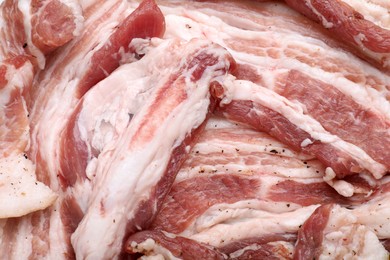 Photo of Tasty pork fatback with spices as background, closeup