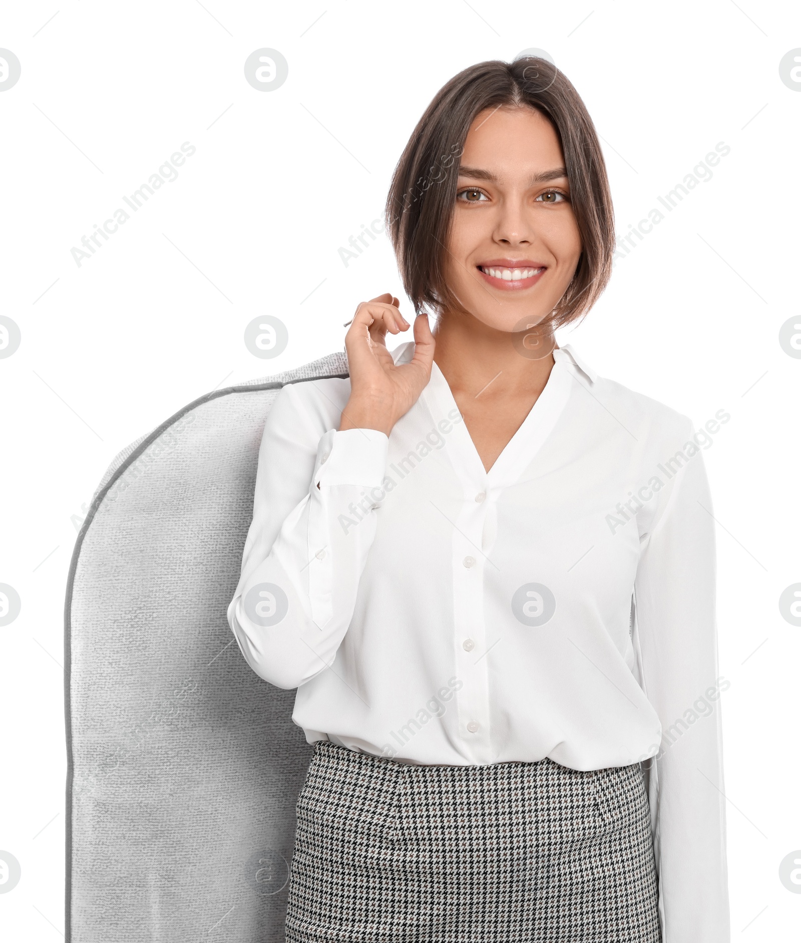 Photo of Woman holding garment cover with clothes on white background. Dry-cleaning service