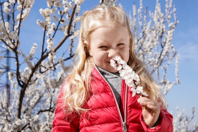 Photo of Happy healthy little girl enjoying springtime outdoors. Allergy free concept