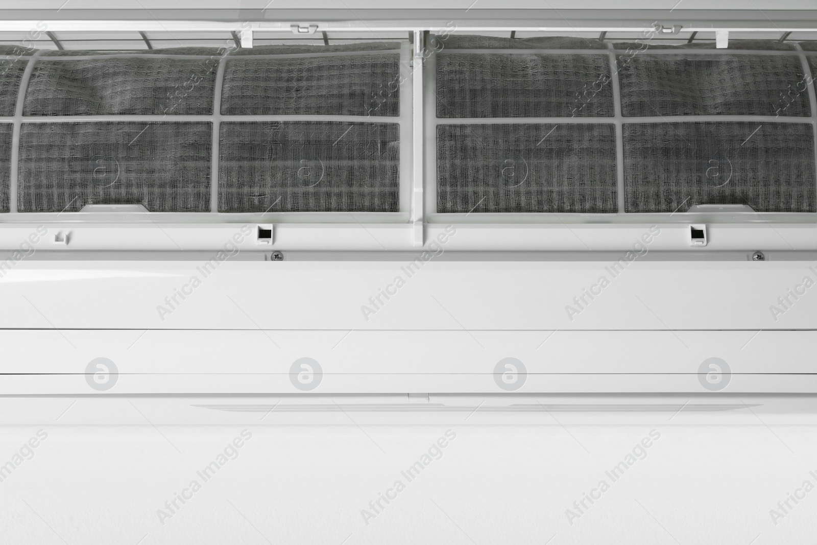 Photo of Modern air conditioner on white wall, closeup