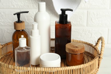 Photo of Bath accessories. Personal care products on table near white brick wall, closeup
