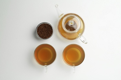 Photo of Buckwheat tea and granules on white background, flat lay