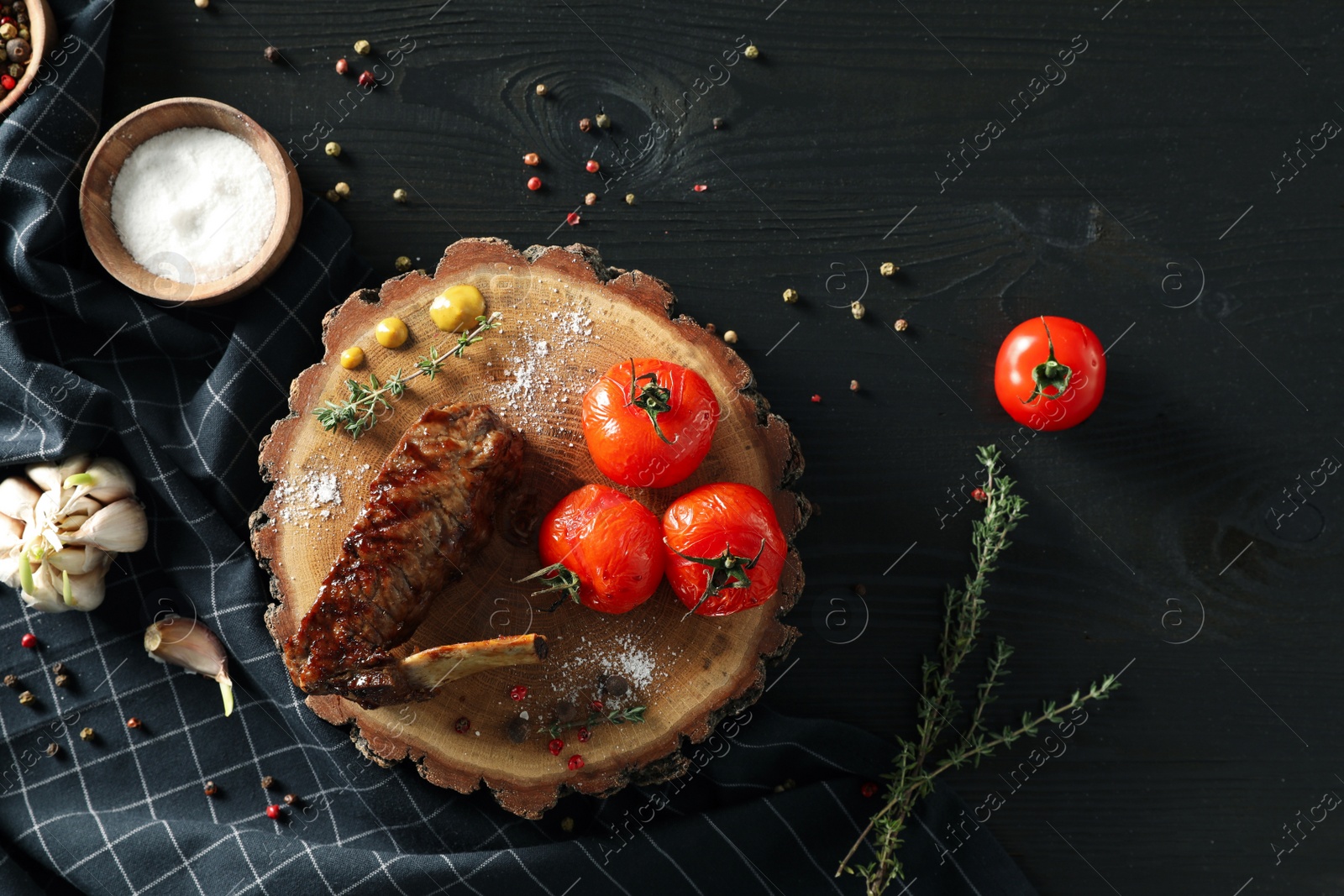 Photo of Delicious roasted rib served on wooden table, flat lay