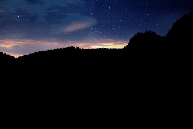 Beautiful view of starry sky over mountains at night