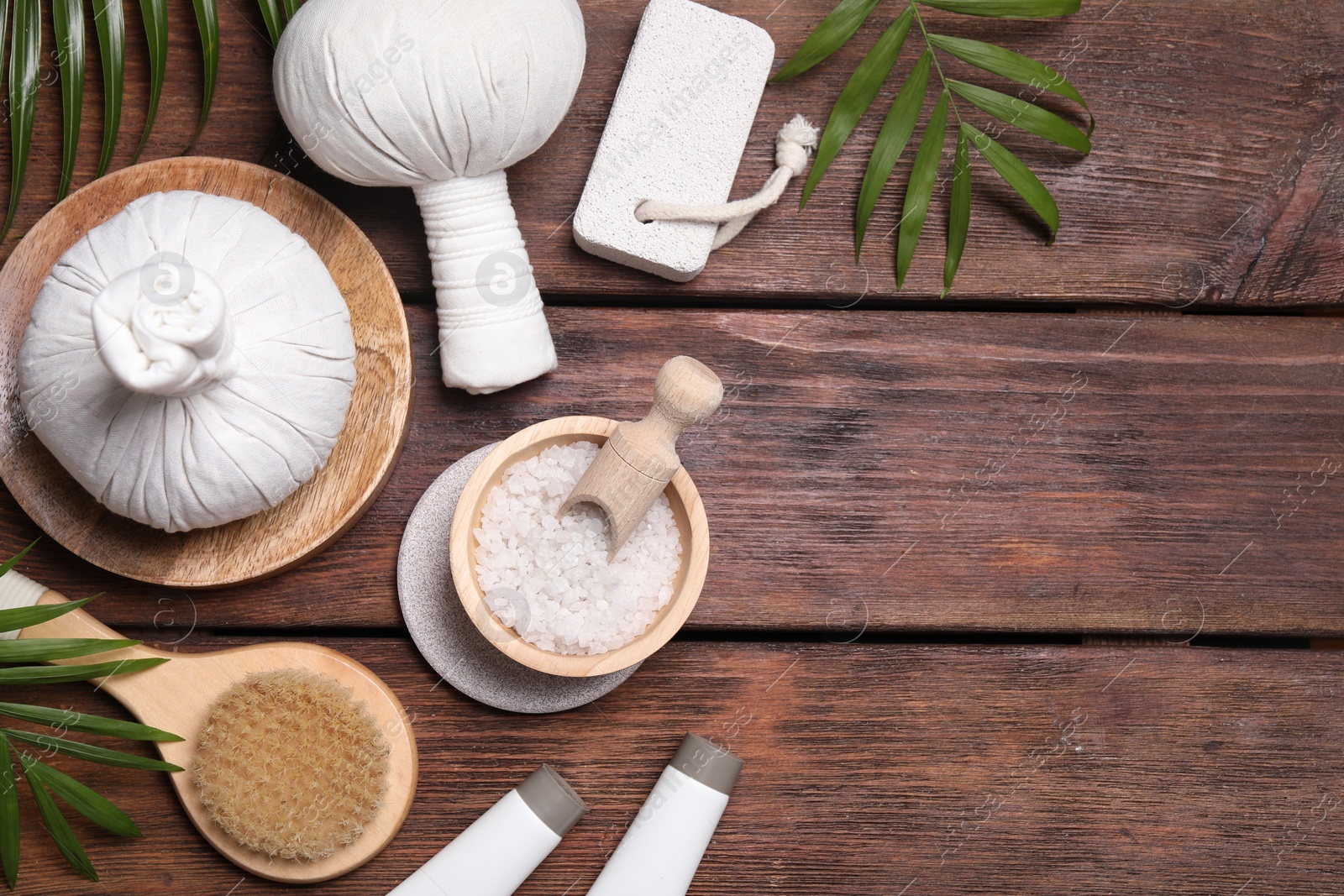 Photo of Flat lay composition with spa products and leaves on wooden table. Space for text