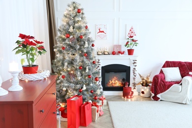 Photo of Living room with fireplace and Christmas decorations. Festive interior design