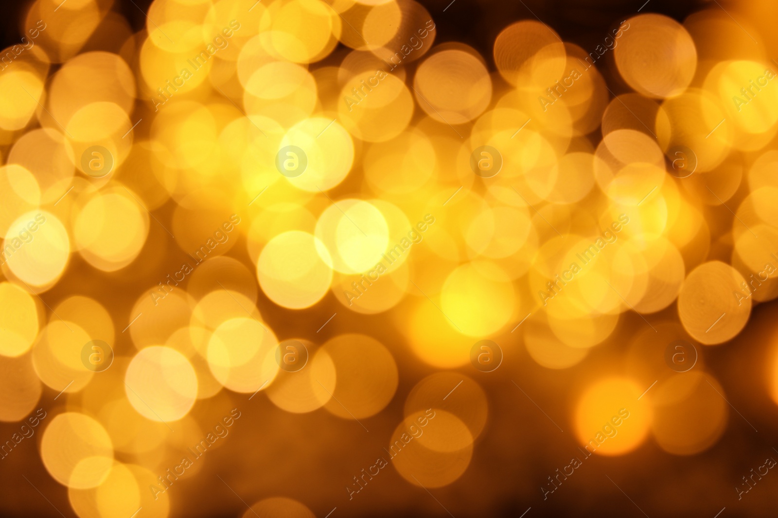 Photo of Gold glitter with bokeh effect on dark background