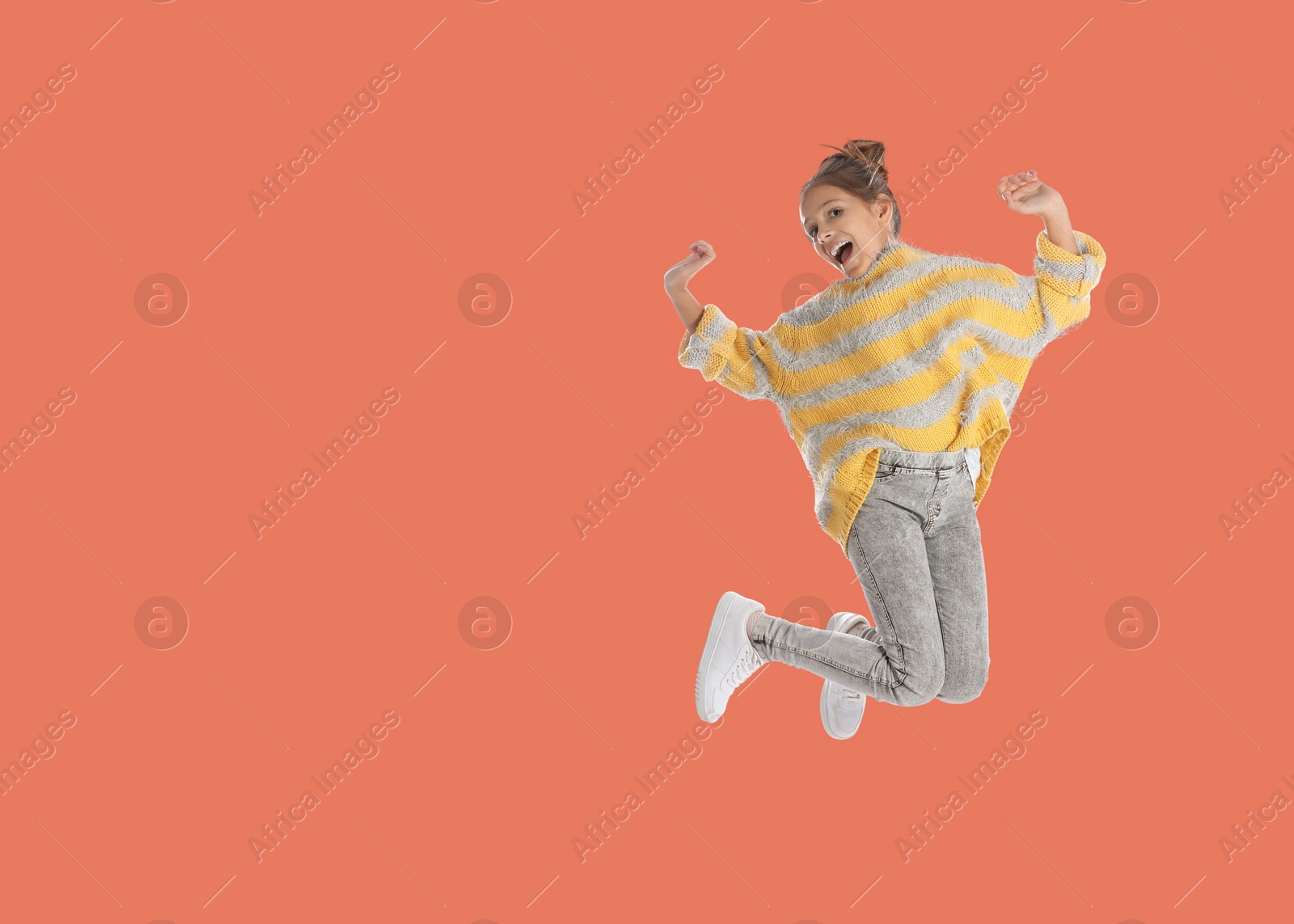Image of Cute girl jumping on coral background, space for text