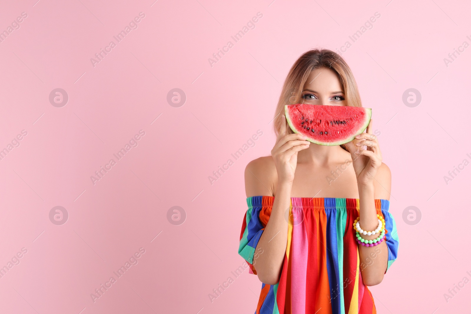 Photo of Pretty young woman with juicy watermelon on color background