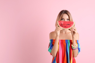 Pretty young woman with juicy watermelon on color background