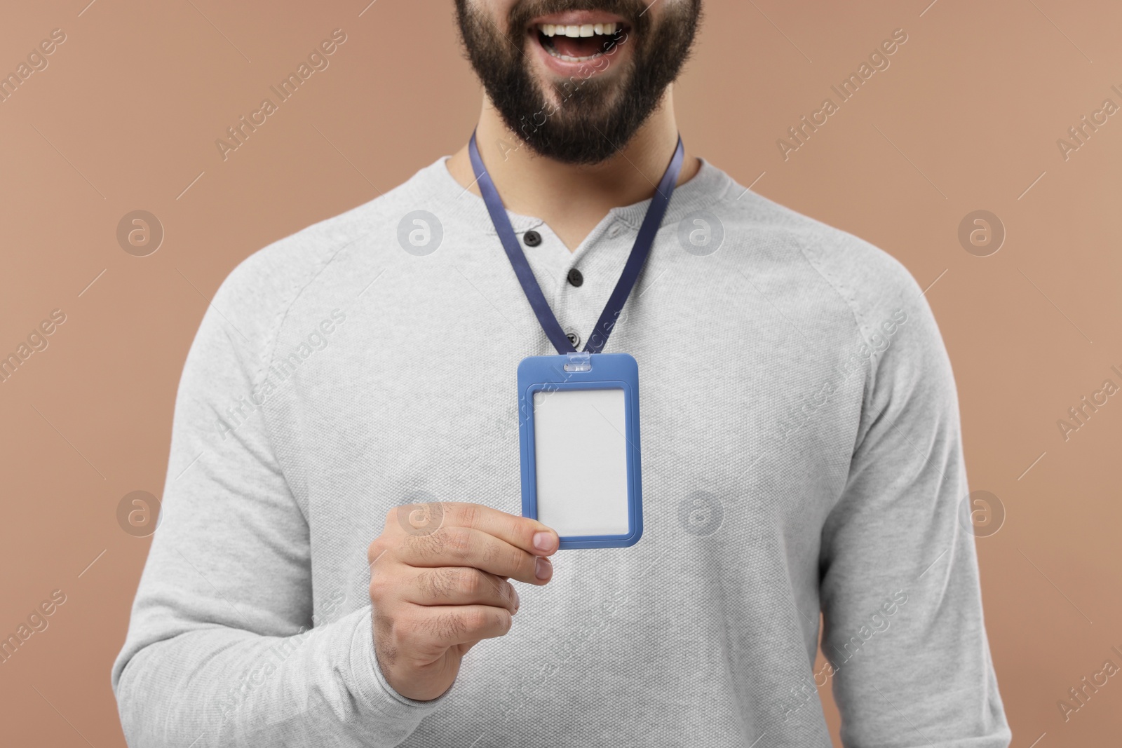 Photo of Man with blank badge on beige background, closeup