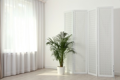 Modern folding screen in light spacious room