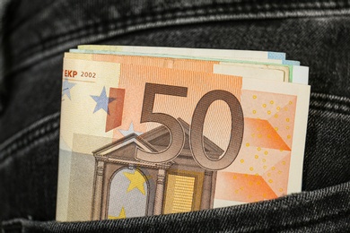 Photo of Euro banknotes in pocket of jeans, closeup