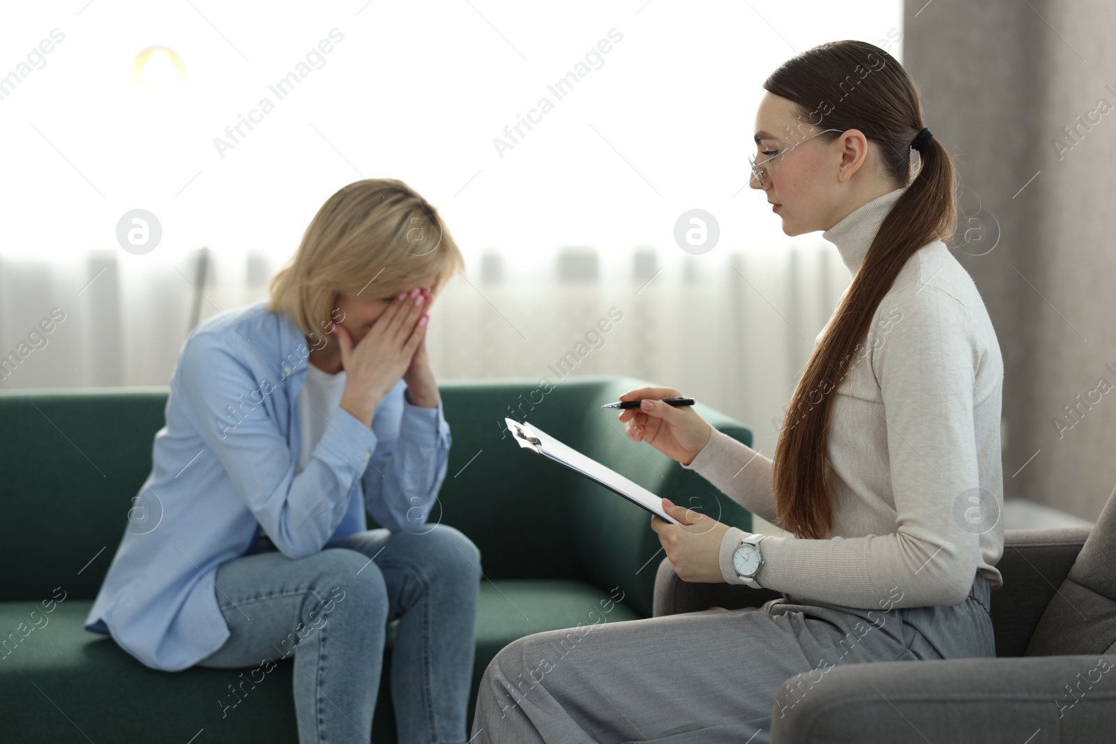 Photo of Professional psychotherapist working with patient in office