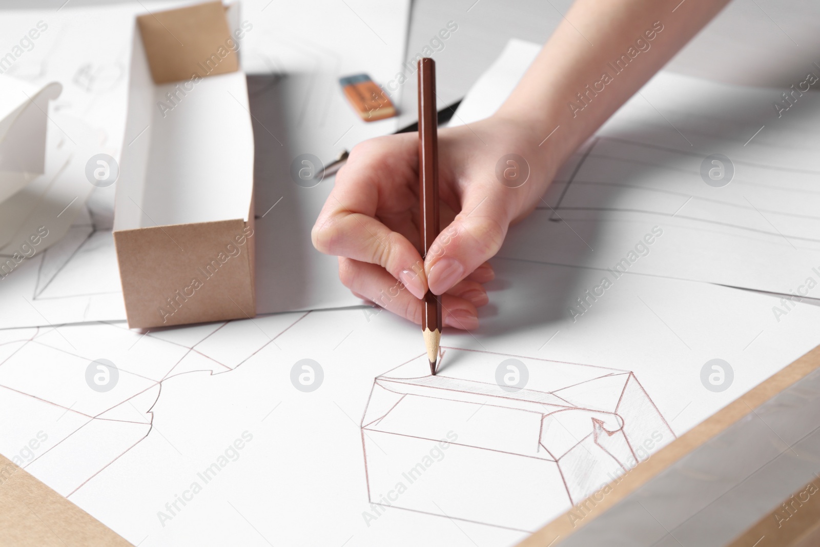 Photo of Woman creating packaging design at table, closeup