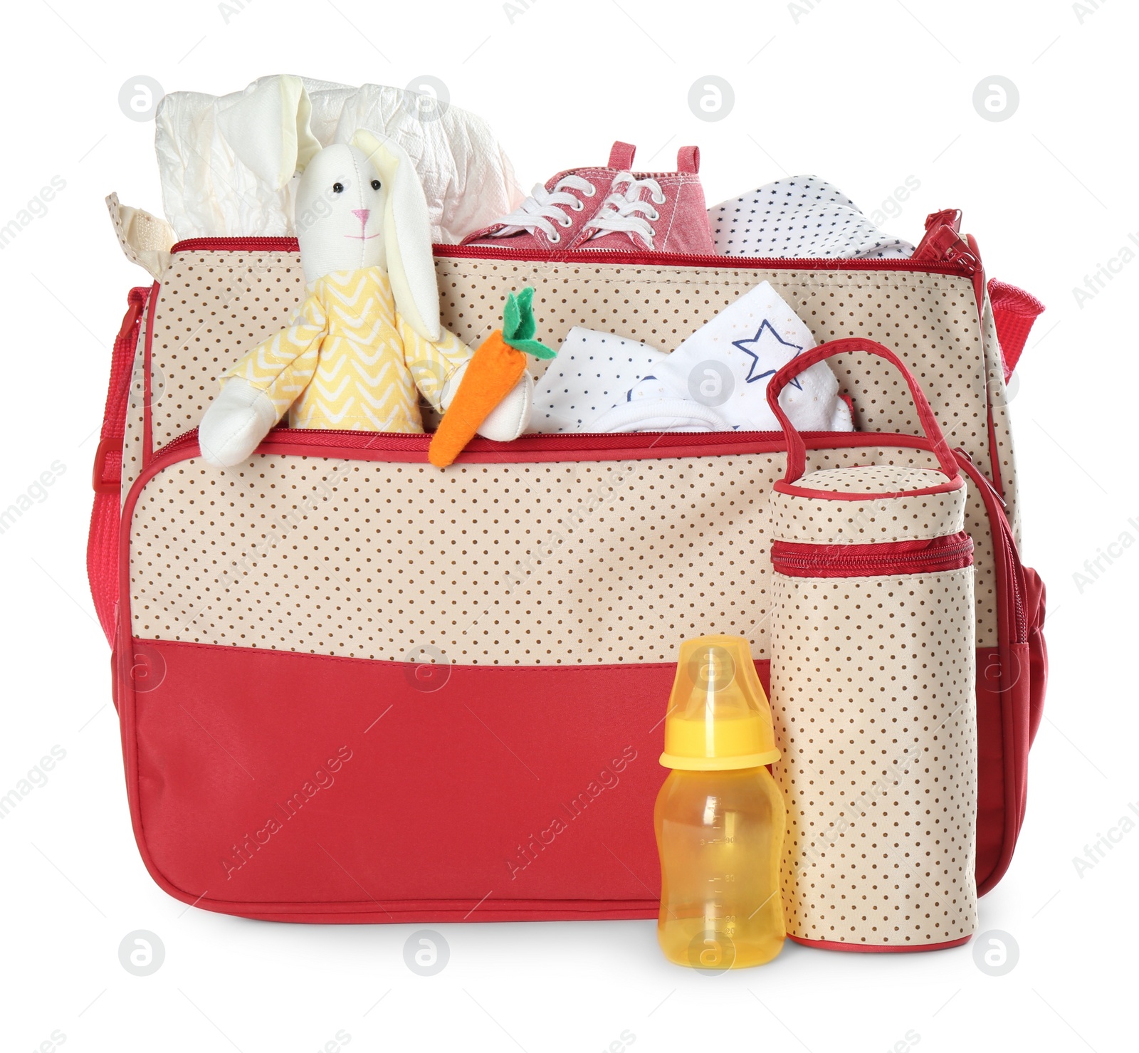 Photo of Maternity bag with child's clothes and accessories on white background