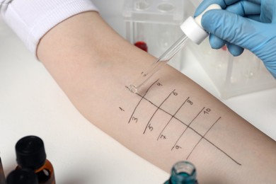 Doctor doing skin allergy test at light table, closeup