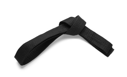 Photo of Tied black belt on white background, top view. Oriental martial arts