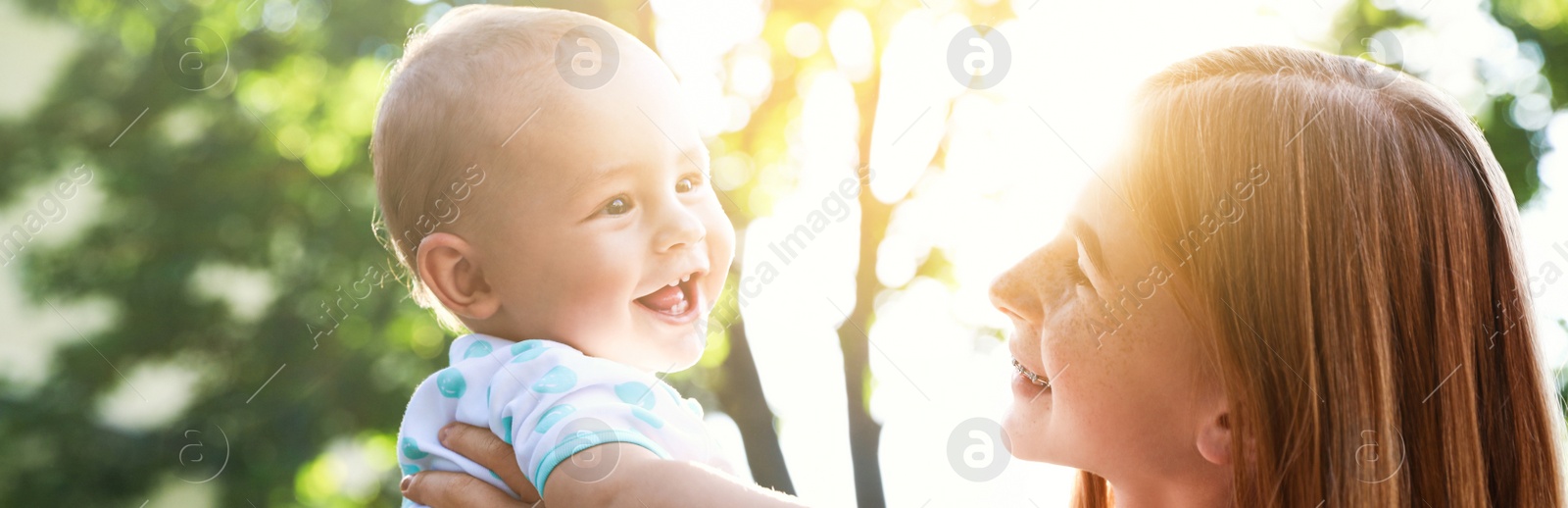 Image of Teen nanny with cute baby outdoors on sunny day. Banner design 