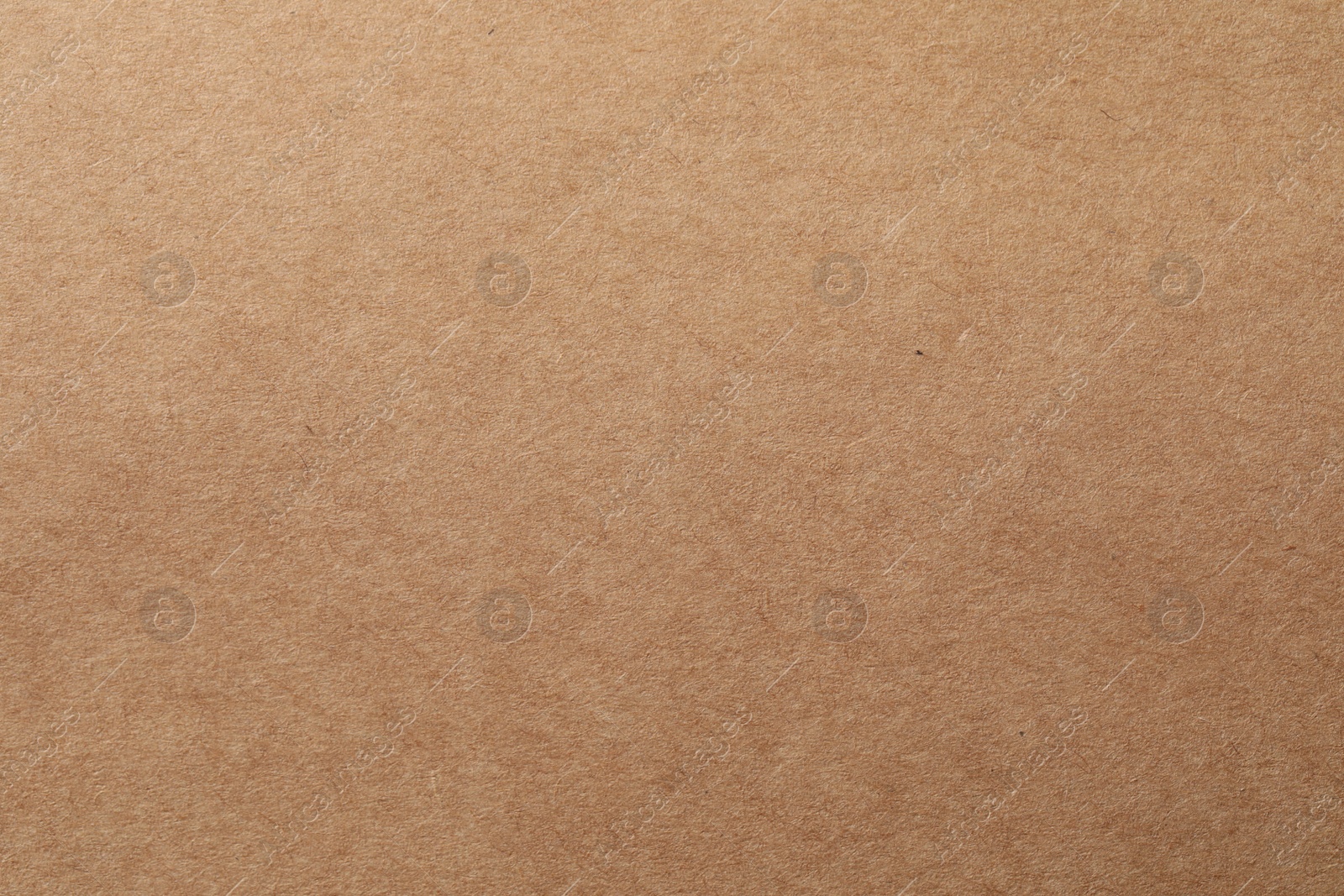 Photo of Texture of kraft paper sheet as background, closeup