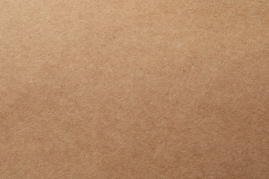 Photo of Texture of kraft paper sheet as background, closeup