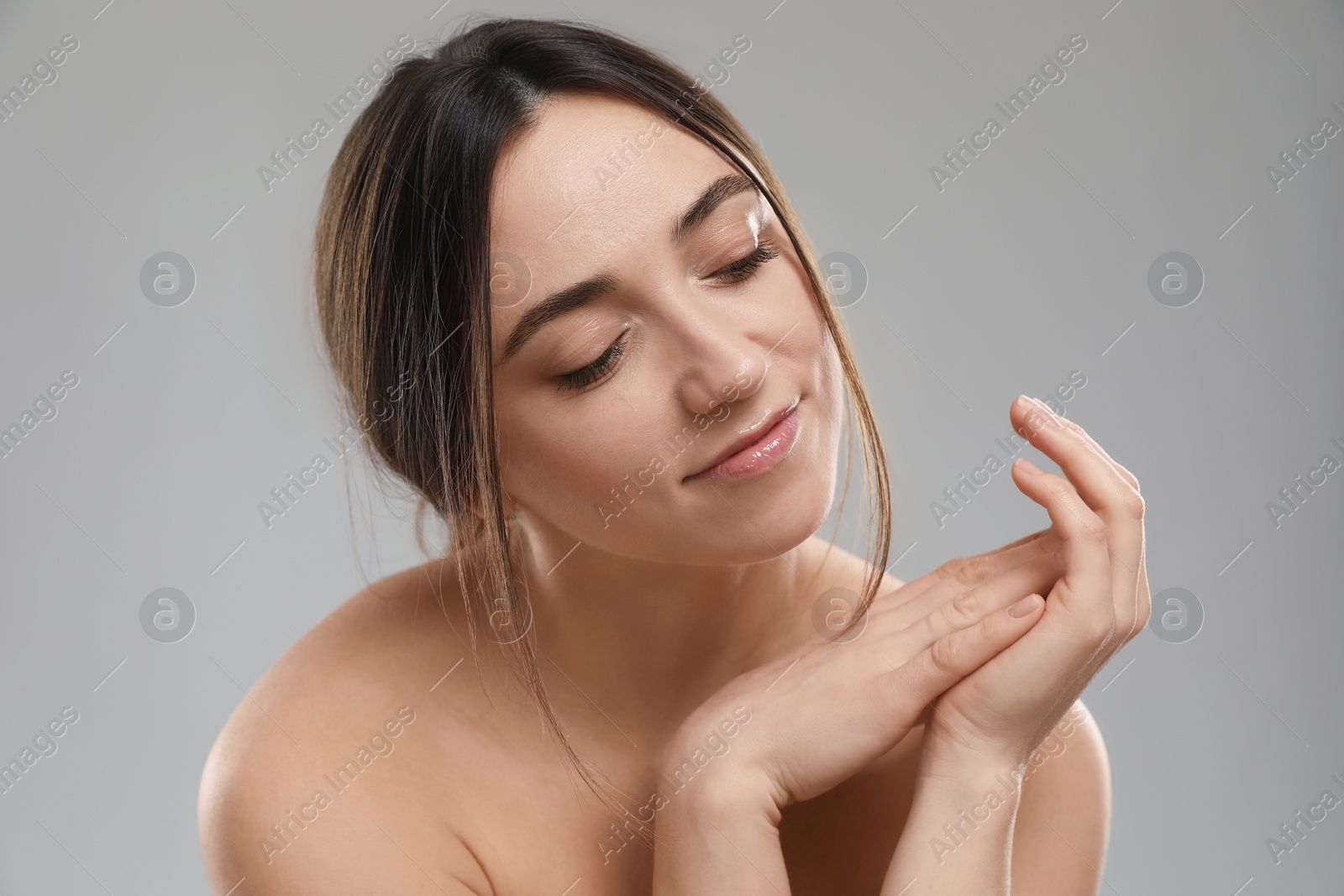 Photo of Portrait of beautiful woman on grey background