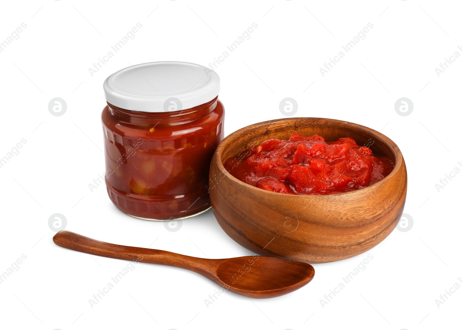 Photo of Glass jar and bowl of delicious lecho on white background