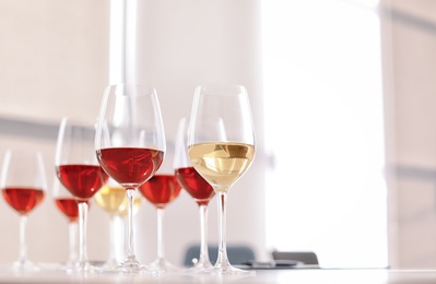 Glasses with delicious wine on table indoors