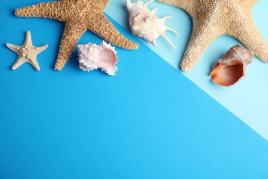 Flat lay composition with beach objects on blue background. Space for text