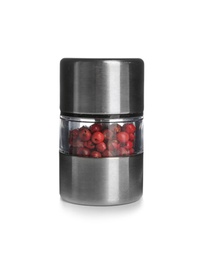 Manual grinder with red peppercorns on white background