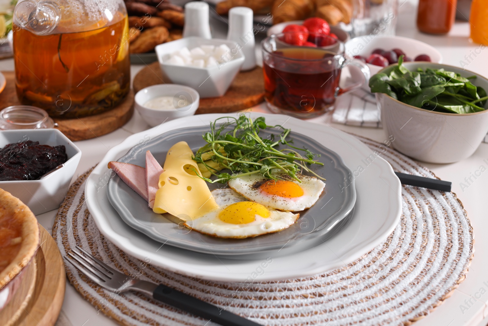 Photo of Fried eggs with sausage and cheese served on buffet table for brunch