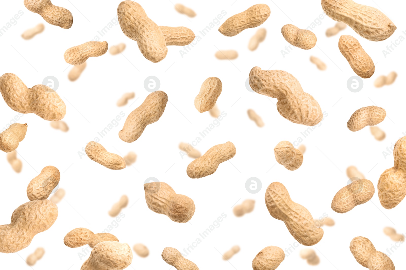 Image of Unpeeled peanuts in air on white background