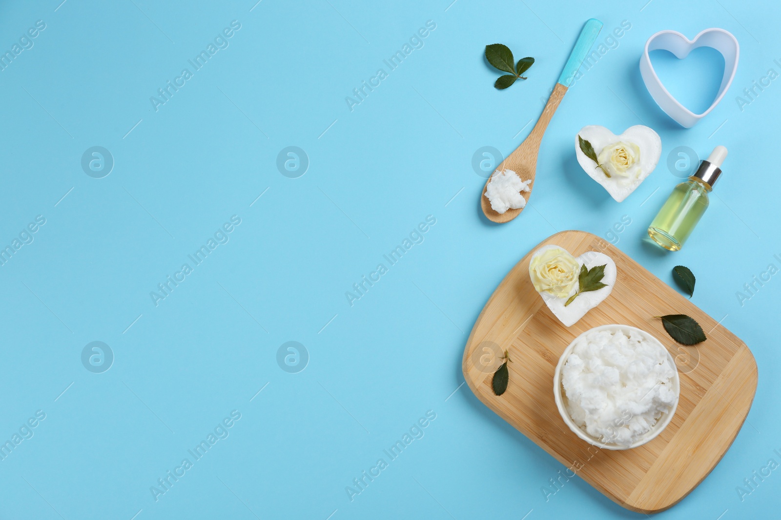 Photo of Flat lay composition with natural handmade soap and ingredients on light blue background. Space for text