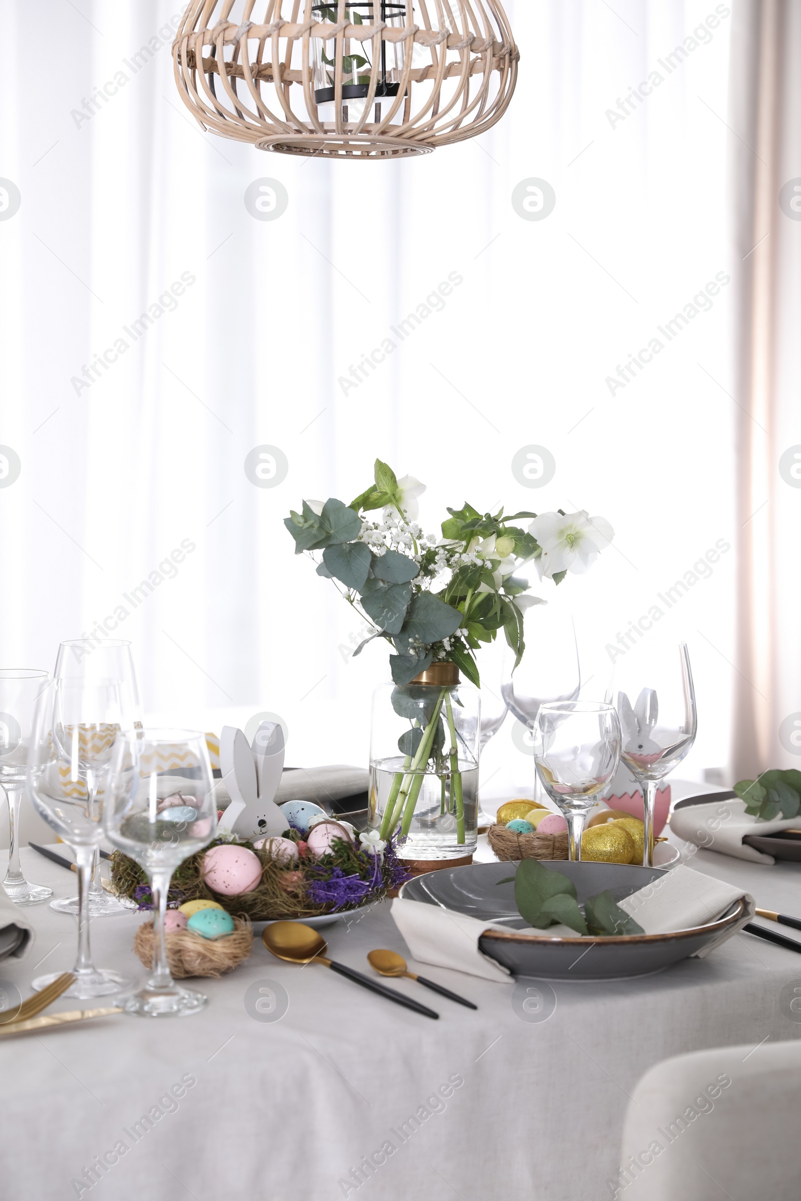 Photo of Beautiful Easter table setting with festive decor indoors