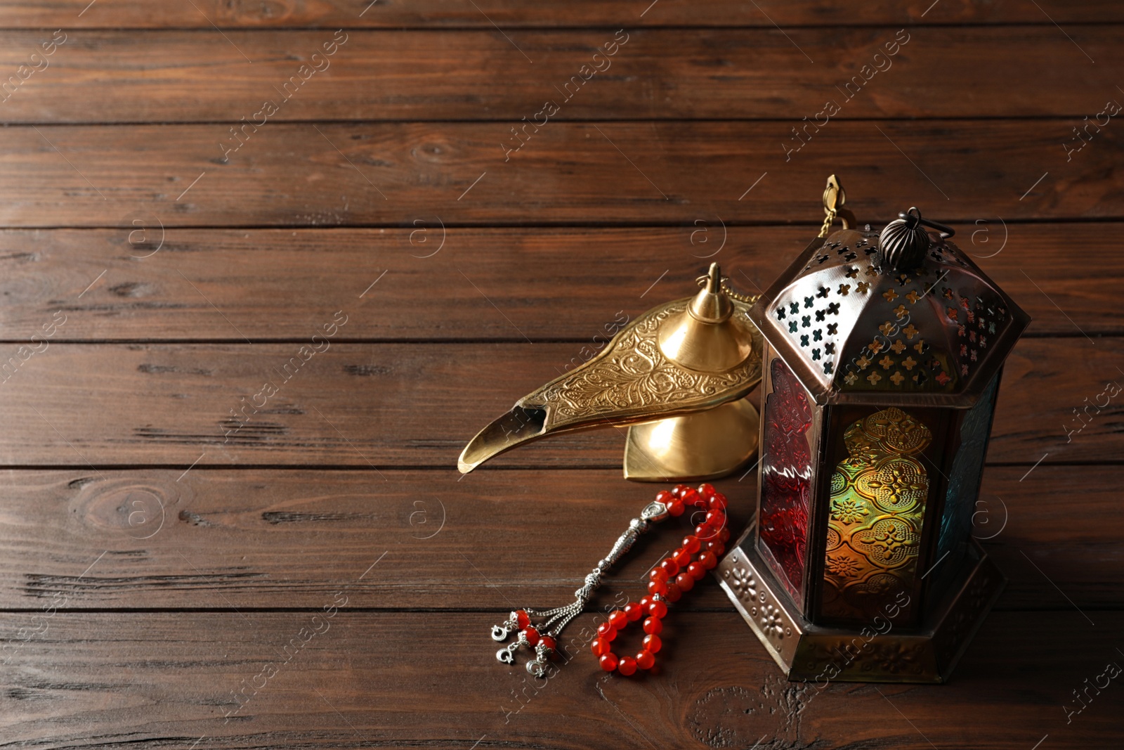 Photo of Composition with Muslim lamp on wooden background. Fanous as Ramadan symbol