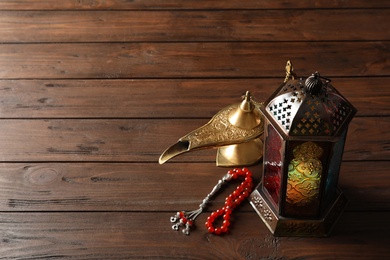 Photo of Composition with Muslim lamp on wooden background. Fanous as Ramadan symbol