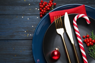 Beautiful Christmas table setting on dark wooden background, flat lay