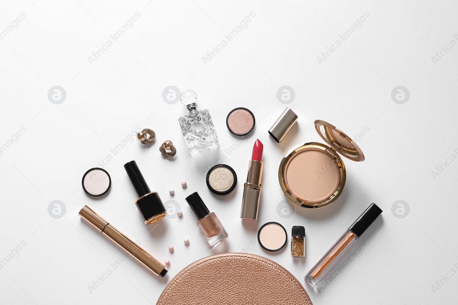 Photo of Cosmetic bag and different luxury makeup products on white background, top view